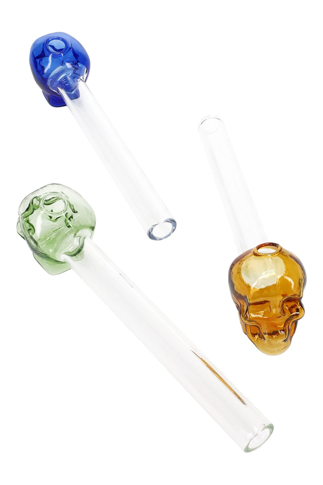 Three 5″ glass skull oil burner pipes with clear stems and colored skull bowls in blue, green, and amber; straight design, sold individually.
