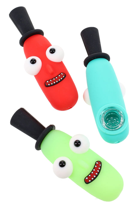 Bright silicone top-hat character hand pipe with removable glass bowl insert, playful eyes and smile, assorted colors on a white background.