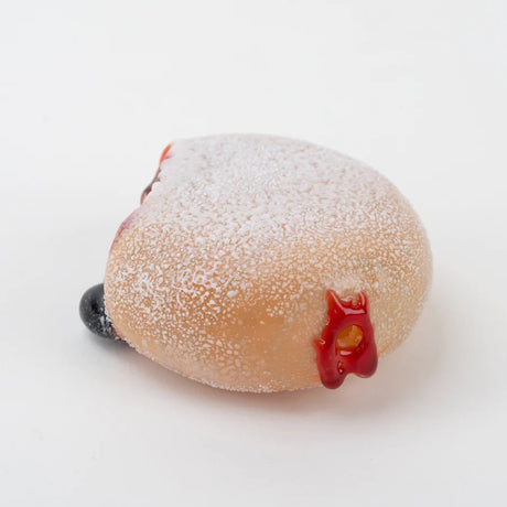 Donut glass pipe with visible mouth opening and black “baked” edge detail on the glaze.