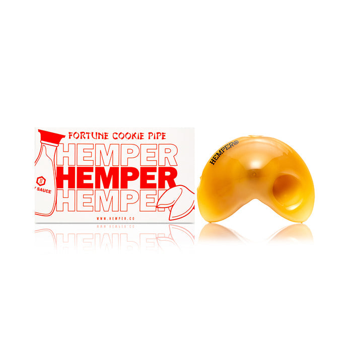 Studio photo of yellow fortune cookie glass hand pipe showing curved cookie profile and smooth glossy finish