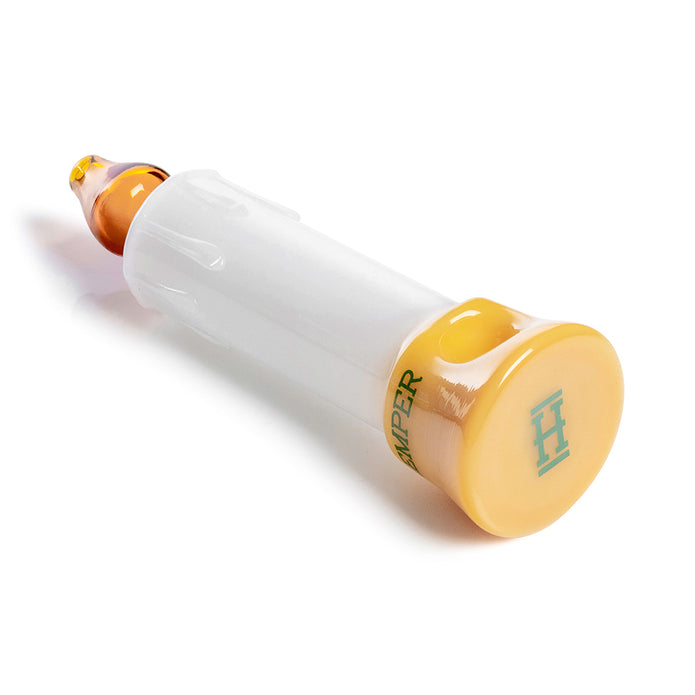 Side view of candle glass hand pipe showing amber mouthpiece, gold base stamp, and textured white body details