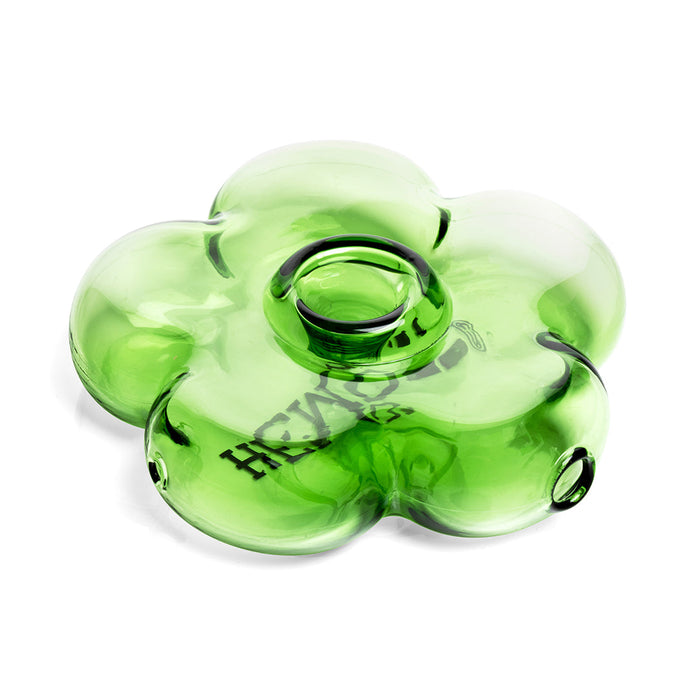 Angled view of green flower glass hand pipe with centered bowl, smooth rim, and thick petal silhouette in clear glass