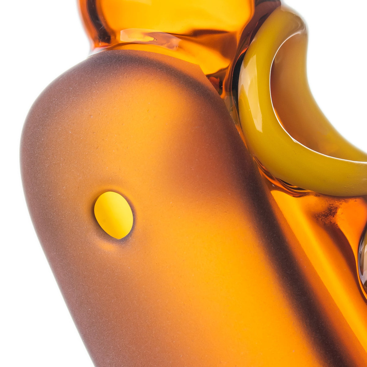 Close-up of BigFun! Glizzy glass hand pipe side carb set into the frosted amber-orange bun-style exterior