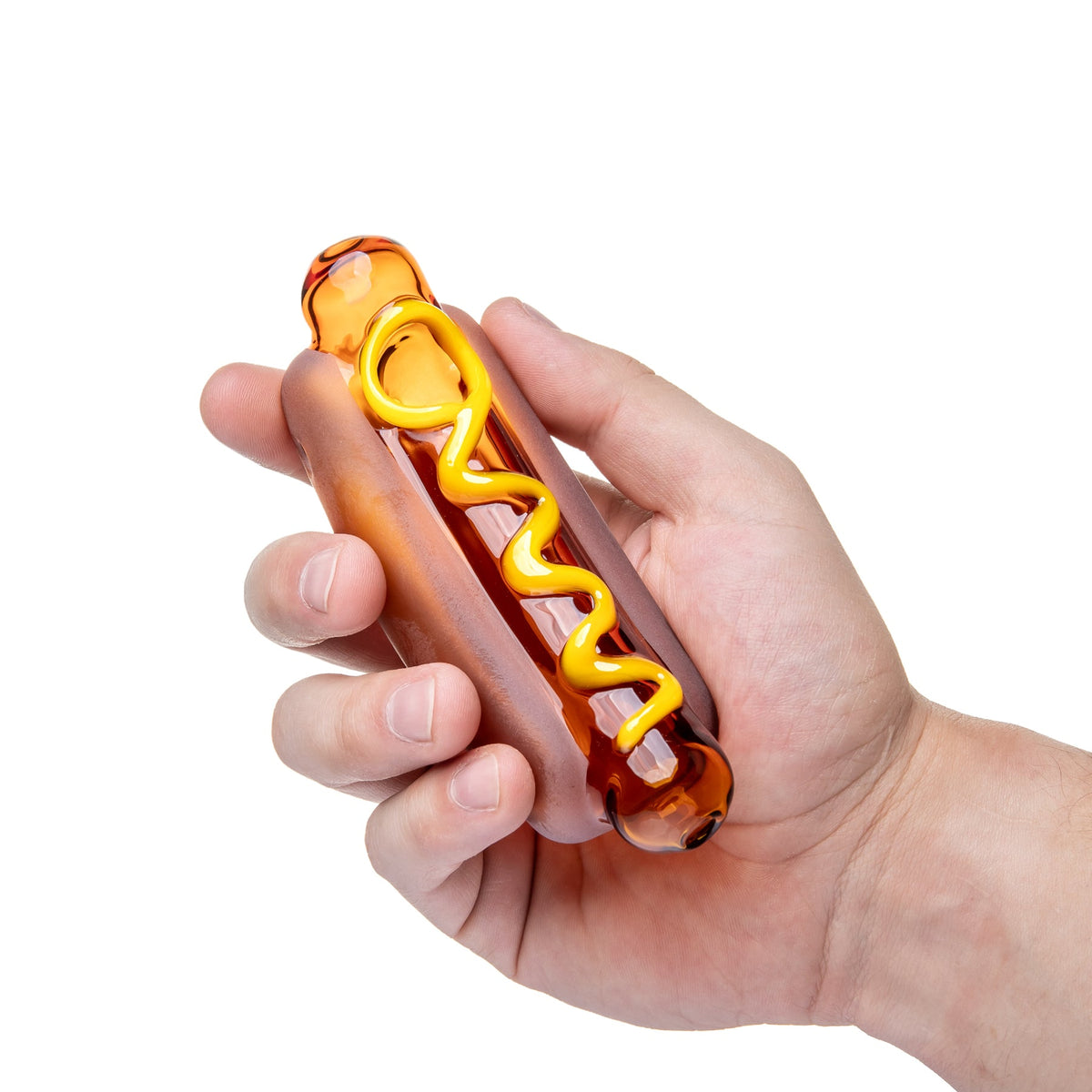 BigFun! Glizzy glass hand pipe held in one hand, showing its compact hot dog shape and raised mustard detail