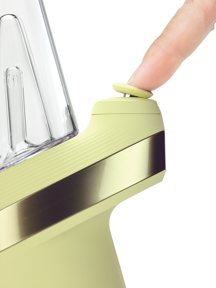 Puffco Peak Zest smart rig close-up with finger pressing the yellow Joystick Cap