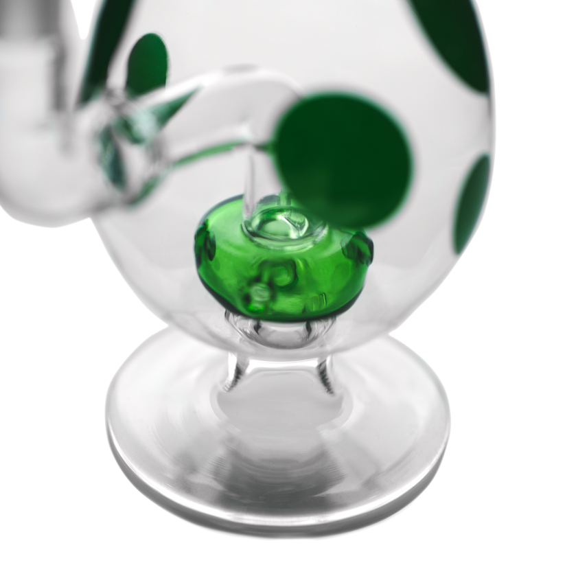 Closeup of green showerhead perc inside spotted egg bong base showing multiple slits for diffusion.