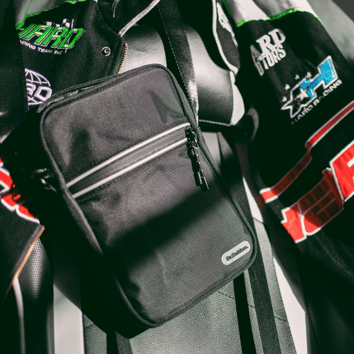 Dr. Dabber travel bag in black with shoulder strap and front zip pocket shown in lifestyle setting