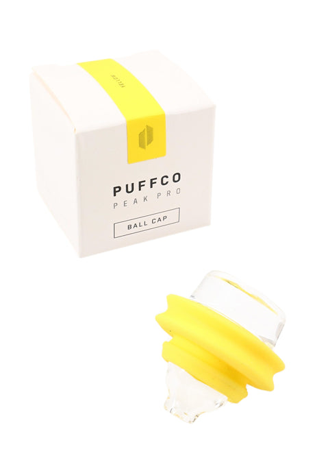 Yellow Peak Pro ball cap shown near packaging; clear glass cap with yellow silicone gasket for a snug, secure fit.