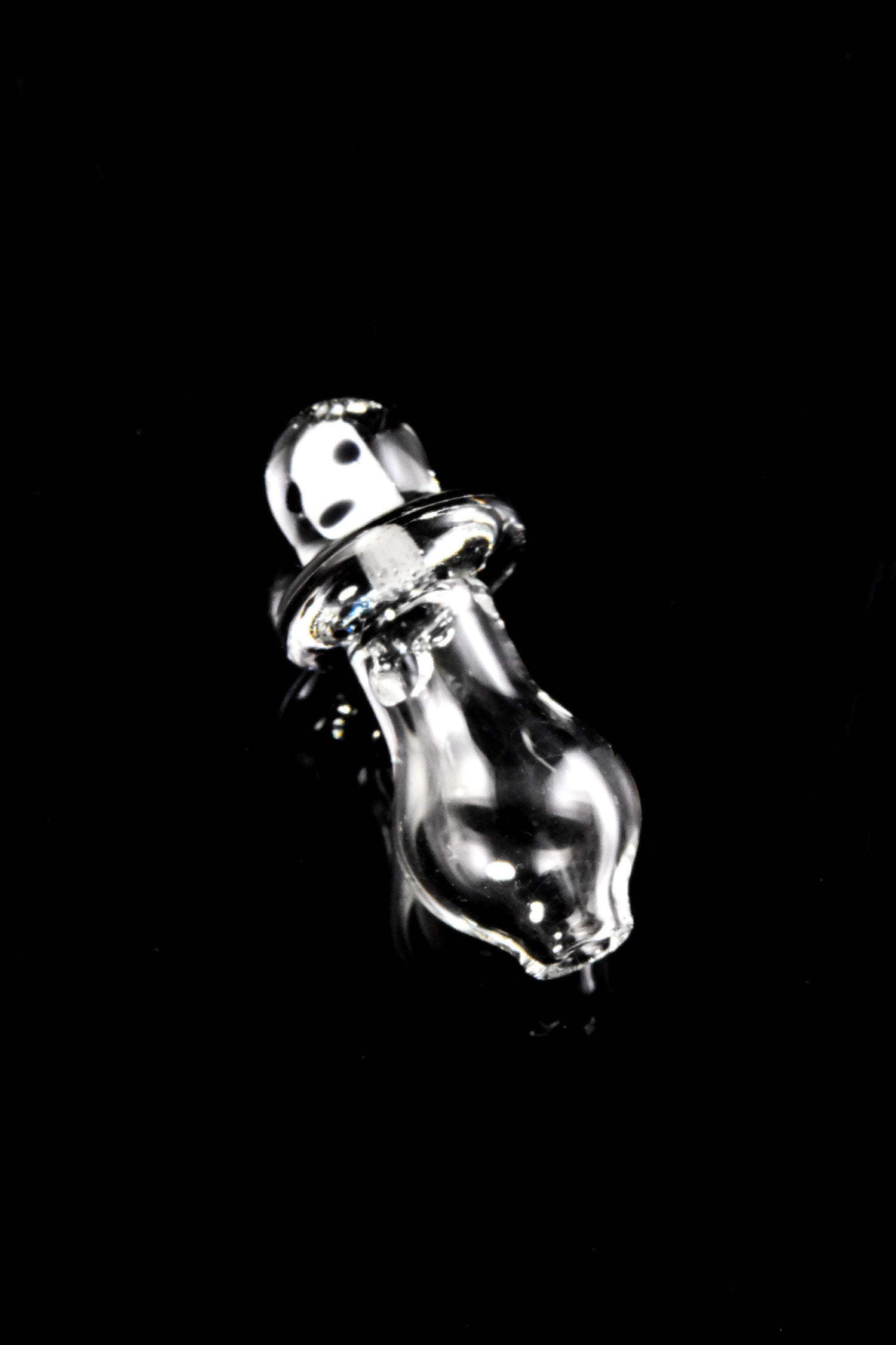 Angled view of Martian Peak Pro glass cap on black background, glossy saucer rim and rounded clear base.