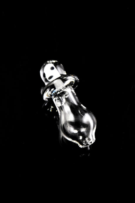 Angled view of Martian Peak Pro glass cap on black background, glossy saucer rim and rounded clear base.