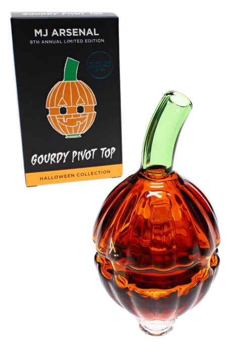“Gourdy” Puffco Pivot replacement glass by MJ Arsenal beside retail box, sculpted pumpkin body with green mouthpiece.