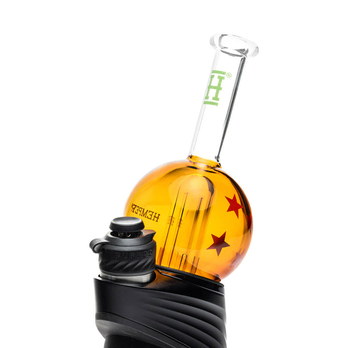 Angled shot of wish ball Peak top installed on device base, orange orb chamber and clear mouthpiece silhouette visible