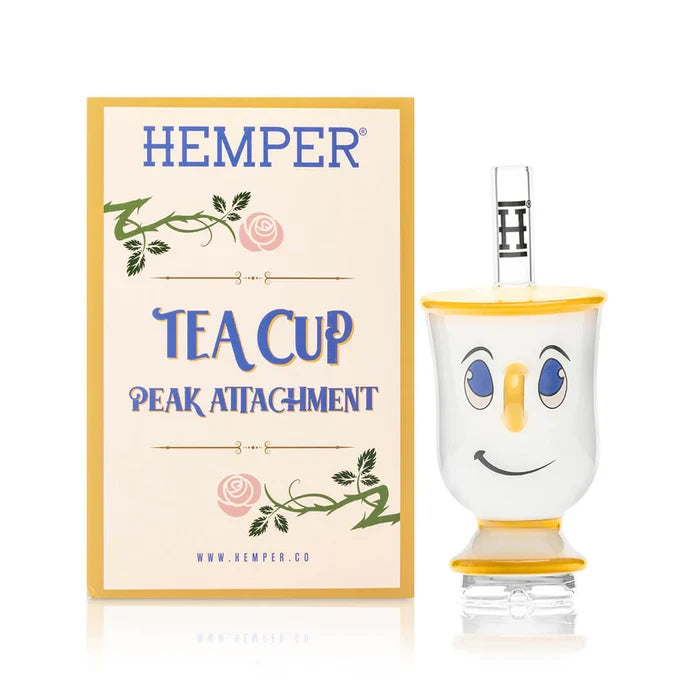 White and yellow HEMPER Tea Cup Puffco Peak Top beside its cream floral-themed retail box