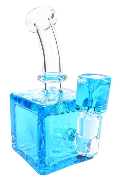 Blue fluid-filled cube glass bong showing square body, curved mouthpiece, and stemless joint with matching bowl.
