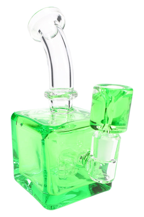 Green fluid-filled cube bong with curved neck and square base, matching bowl seated in glass-on-glass joint.