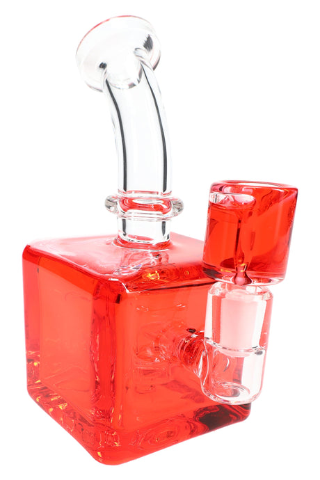 Red fluid-filled cube bong highlighting square chamber, curved mouthpiece, and stemless joint with matching bowl.