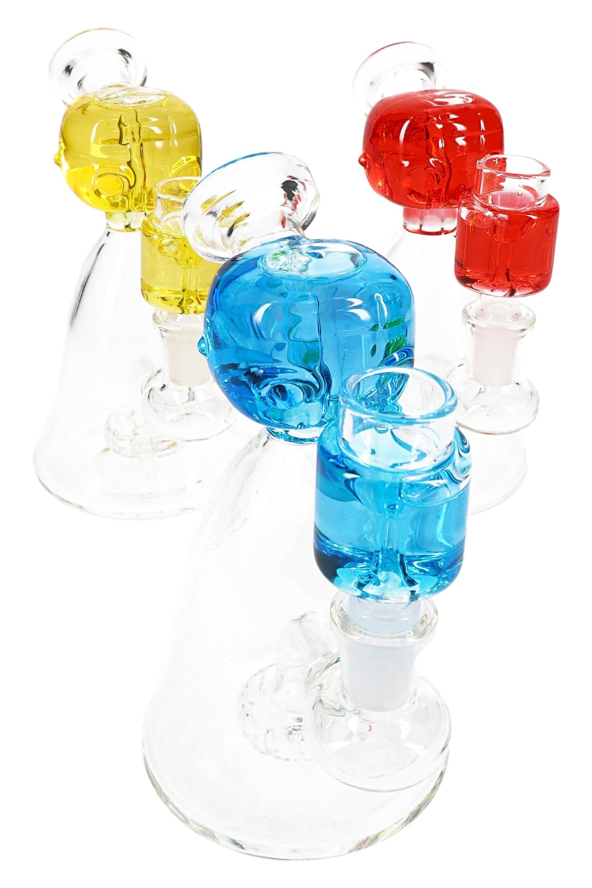 Group of small fluid-filled glass beaker bongs with alien heads, showerhead percs, and GoG joints in red, yellow, and blue.
