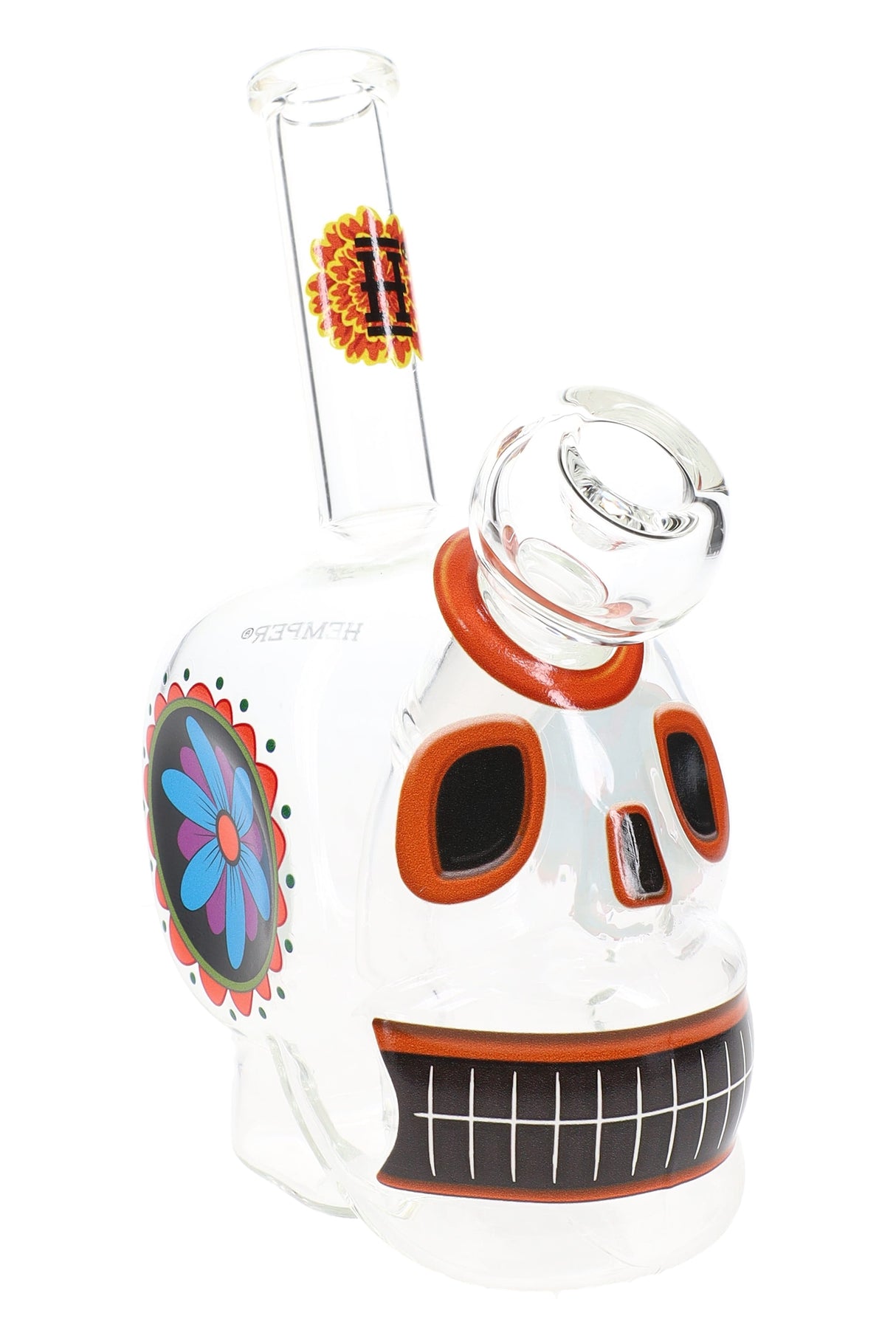 Clear Hemper Dia De Los Muertos skull glass bong with orange-trimmed eyes and angled neck, close-up hero shot on a white background.