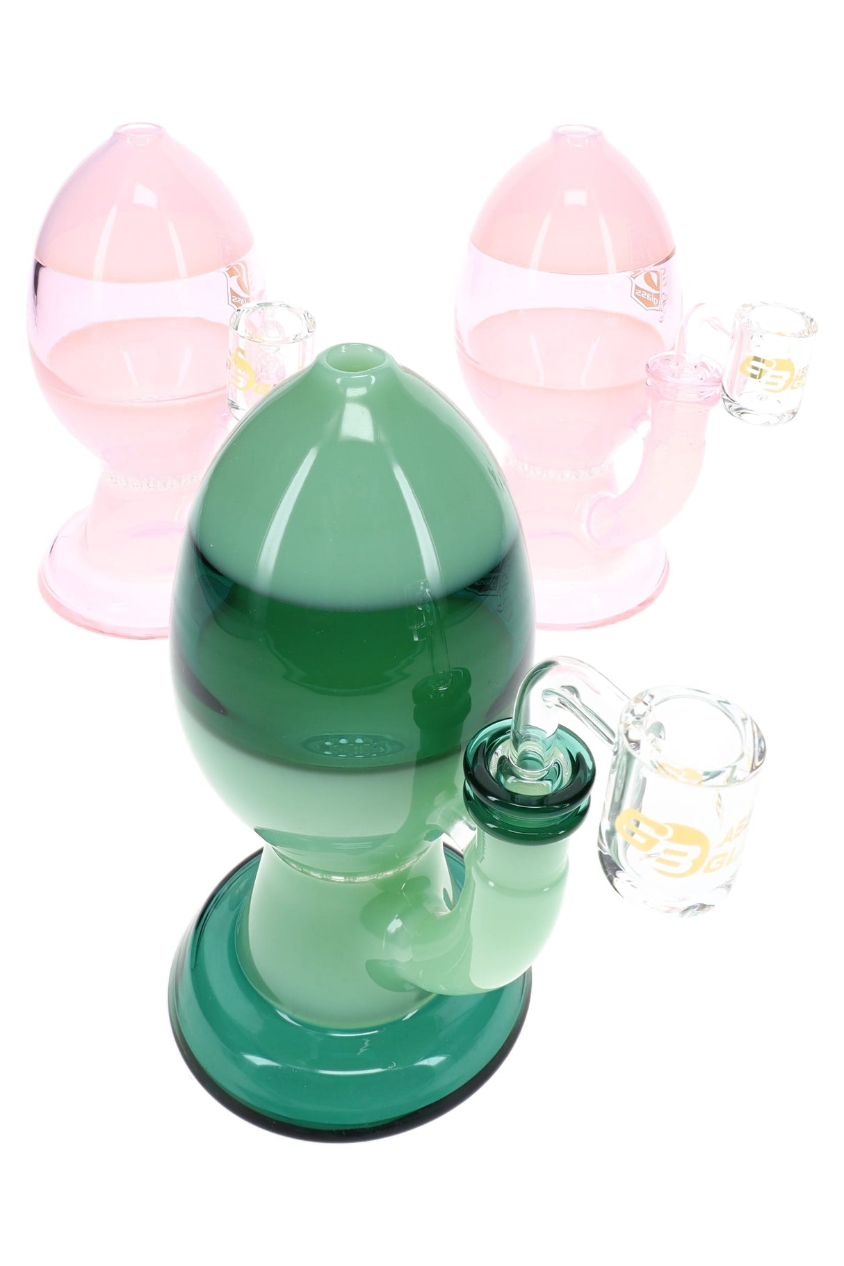 Assorted pink and green egg dab rigs with rounded bodies, honeycomb percs, and clear angled bangers