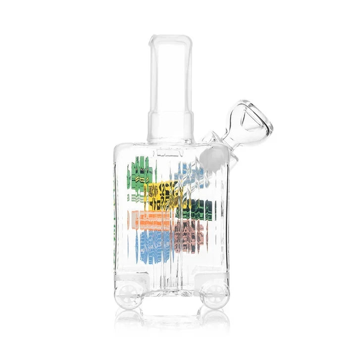 Rear view of the clear HEMPER Suitcase Medium Bong showing ribbed glass, sculpted wheels, and glass bowl