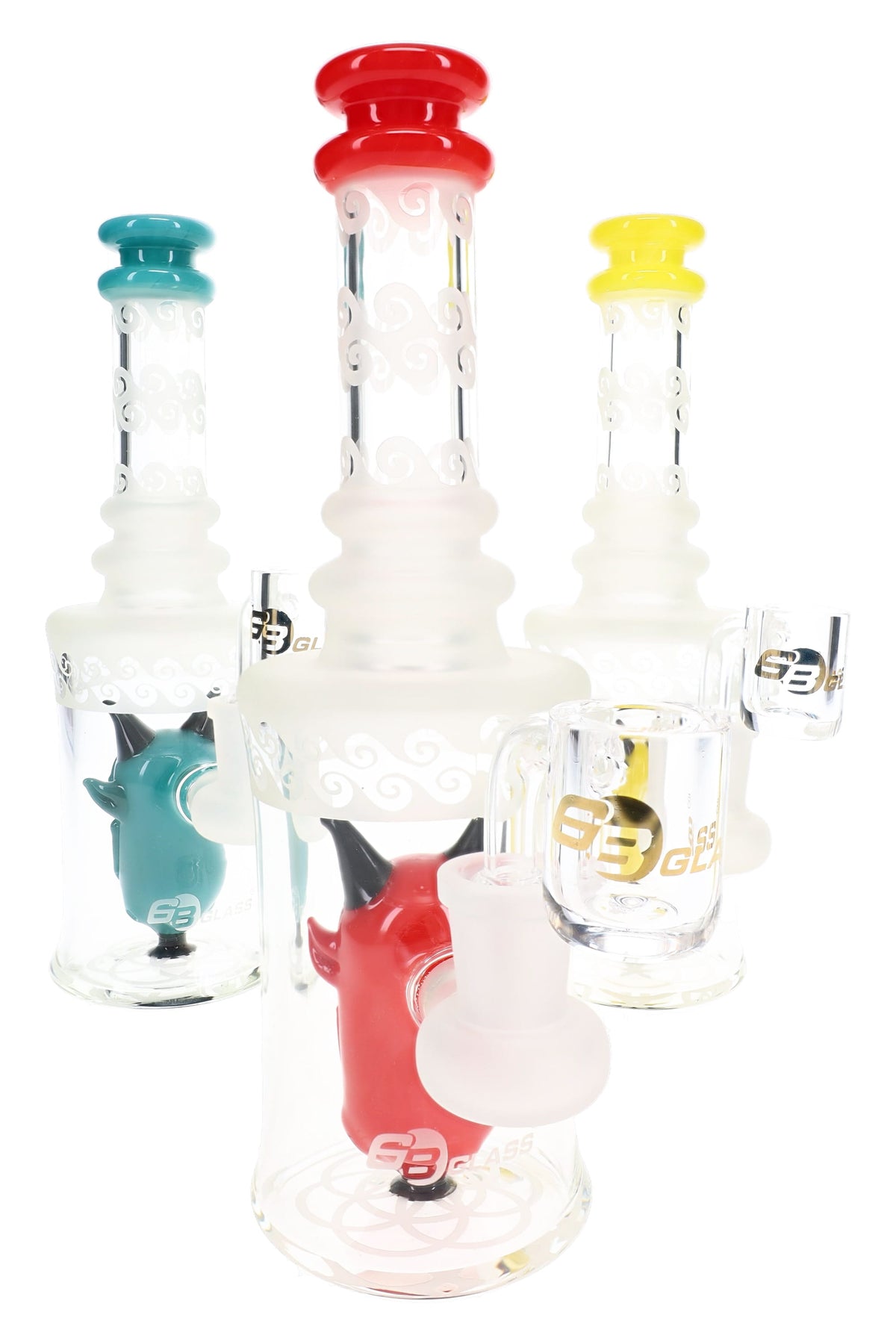 Three 6B Glass frosted demon dab rigs with red, teal and yellow accents, horned character percs and clear bangers.