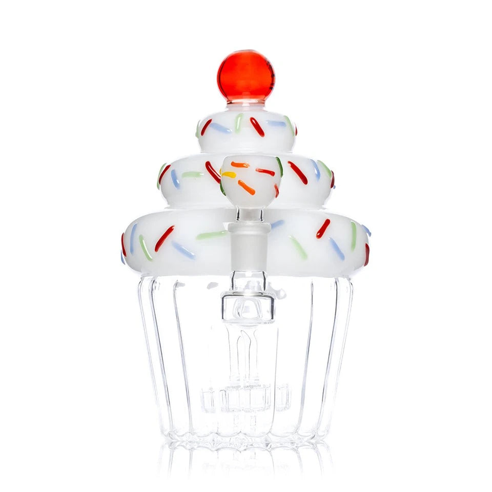 Bowl-end view of Hemper Cupcake XL bong with a sprinkle-decorated bowl in front of stacked white frosting
