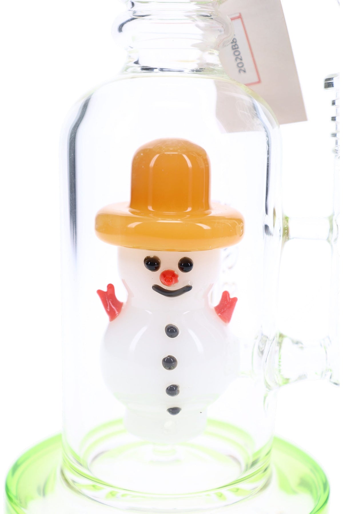 Close-up of white snowman percolator with orange hat, red arms and nose, black buttons, and smiling face.