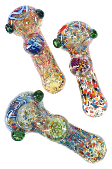 Five-inch confetti frit glass spoon pipe with color-changing body, floral marble accent, and roll-stop side marbles in assorted colors.