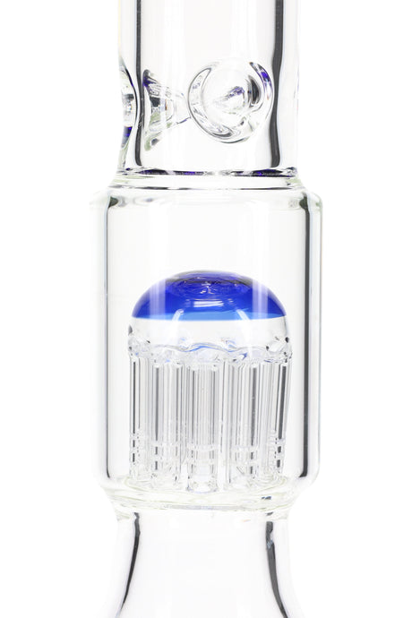 Close-up of domed tree percolator chamber on a clear beaker bong, vertical slits visible beneath the colored cap.