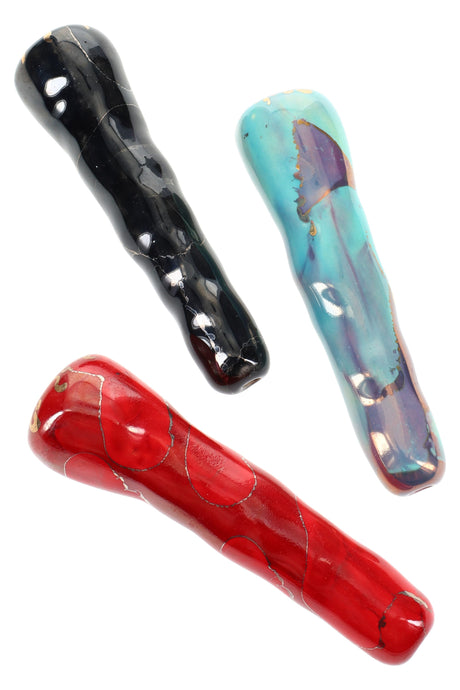 Three 4-inch ceramic chunky bat chillums in black, turquoise, and red, glossy finish with subtle marbling, compact one-hitter shape.