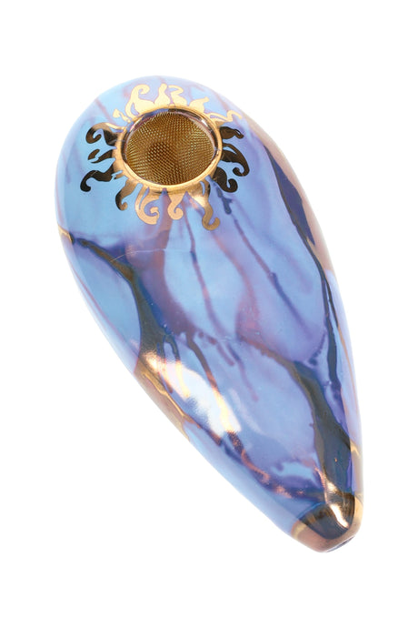 Blue-violet 4″ oval ceramic hand pipe with gold sun accent and brass screen bowl, glossy marbled glaze.