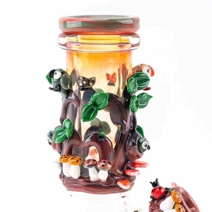 Close view of the worked redwood neck with leaves, birds, mushrooms, and glossy details on a compact beaker bong.