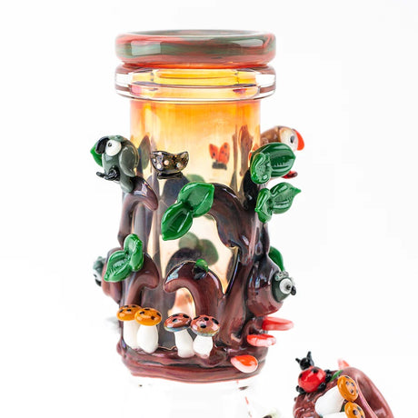 Close view of the worked redwood neck with leaves, birds, mushrooms, and glossy details on a compact beaker bong.