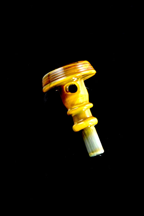 Vintage color Puffco glass joystick shot on a black background, compact directional airflow accessory with a rounded cap.