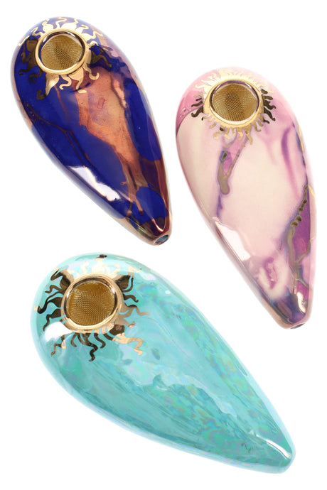 Trio of 4-inch oval ceramic hand pipes with brass screen bowls and gold sun rims in blue, pink, and teal glazes.