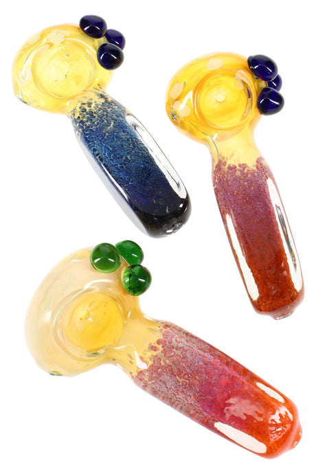 5″ color-changing fumed frit square glass spoon with bubble bowl and marble roll-stoppers, shown in assorted colors.