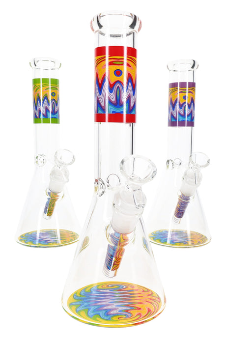 Clear 10″ glass beaker bong with rainbow wig-wag label on neck and matching base disc, ice pinch and 18.8 mm GoG joint.