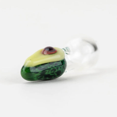 Macro view of avocado cap tip highlighting domed pit and smooth glass finish; clear base transitions to textured green body.