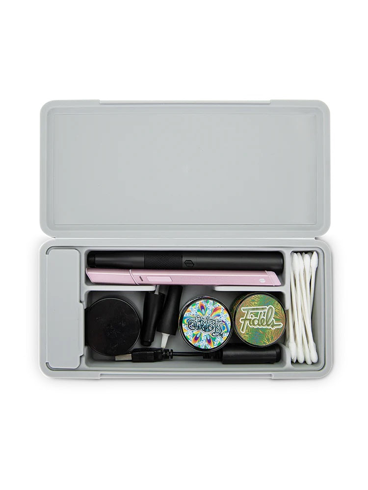 Case packed with two pens, jars, charger and swabs, demonstrating versatile storage for daily dabbing essentials.