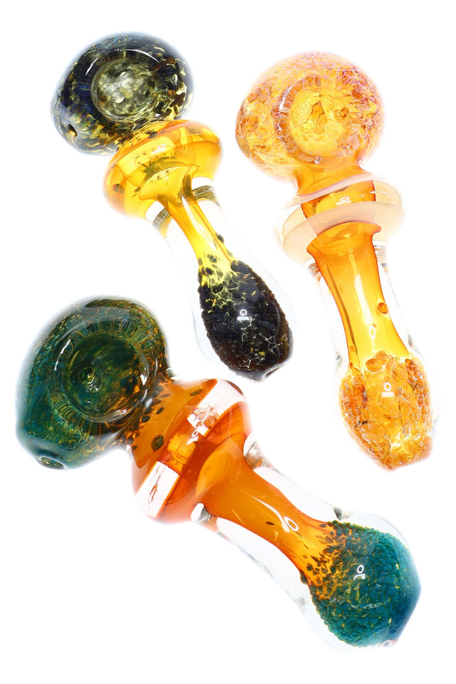 4½-inch gold-fumed color-changing glass spoon with orb bowl, maria ring, and frit accents at the tip, shown in assorted colors.