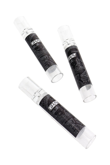 Three clear GRAV 12 mm glass taster one-hitters with black line-art wraps, compact borosilicate tubes shown on a white background.