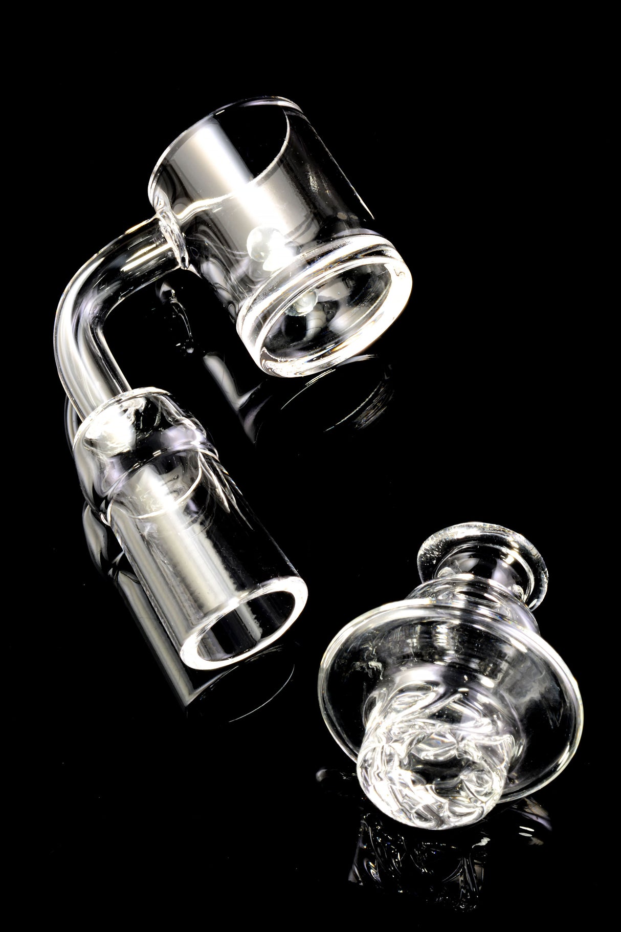 Angled shot of domeless quartz spinner banger showing 2 mm walls and 5 mm base with cap beside it.