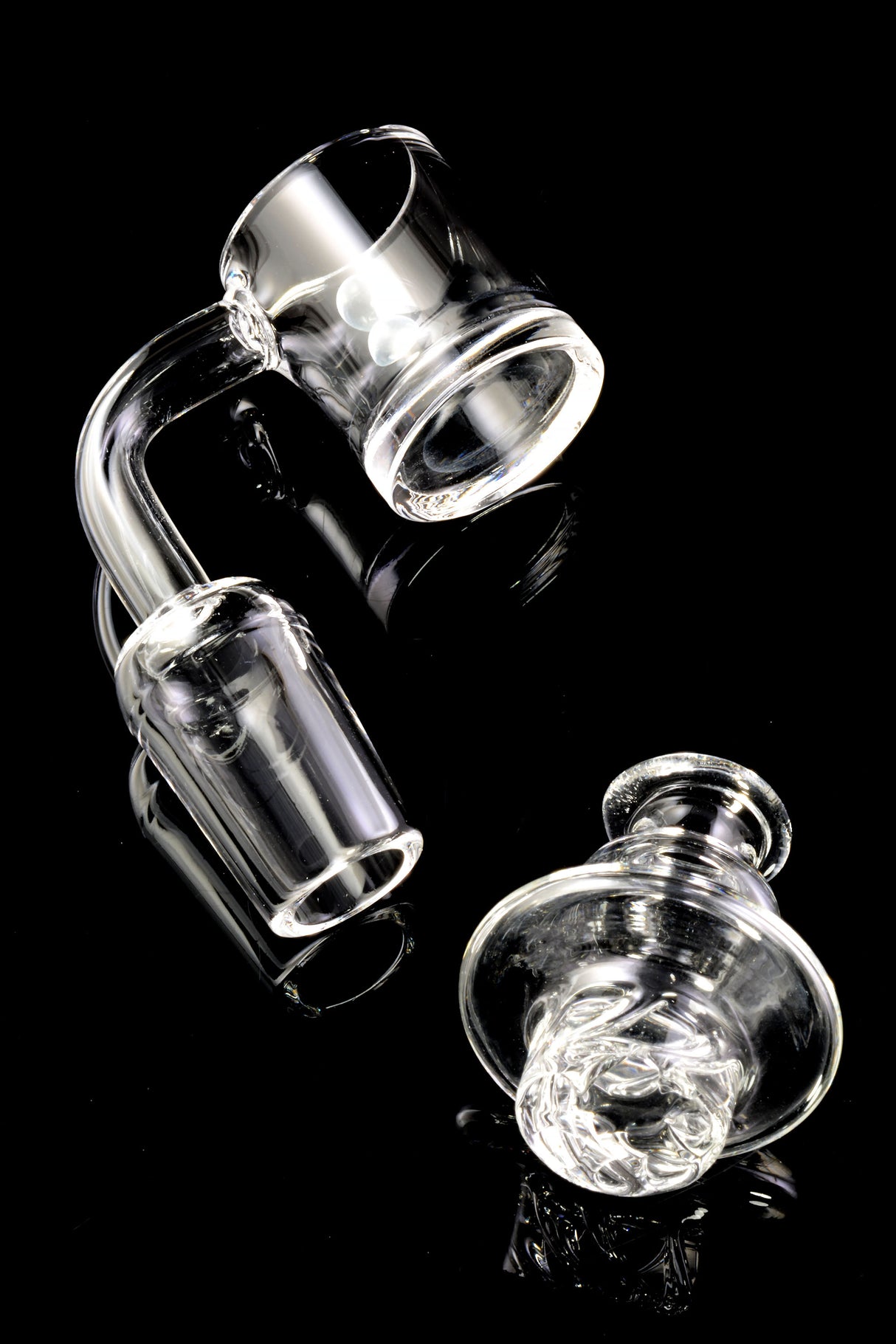Quartz spinner banger with thick bottom base and included turbine carb cap; clean clear finish on black backdrop.