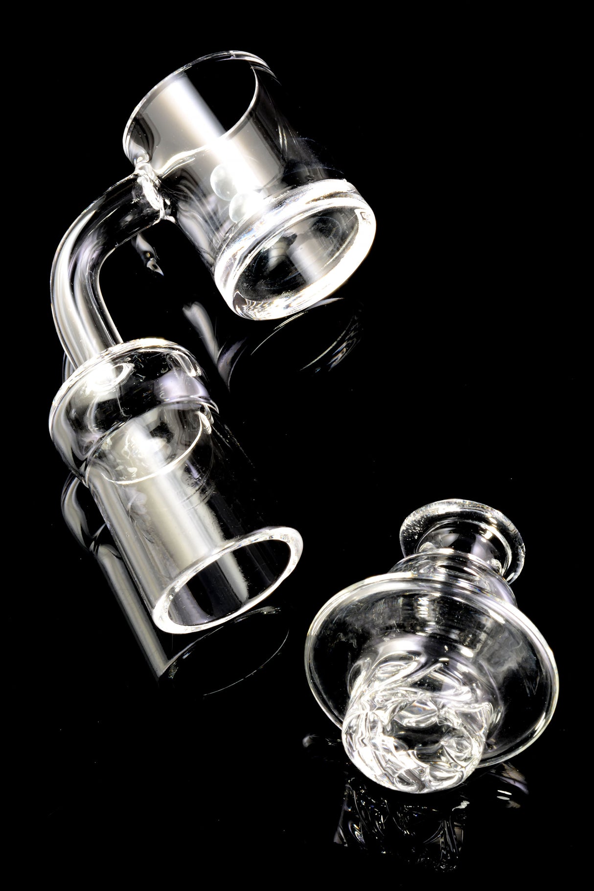 Quartz spinner banger displayed with turbine cap; two banger beads visible in bucket for smooth spinning airflow.