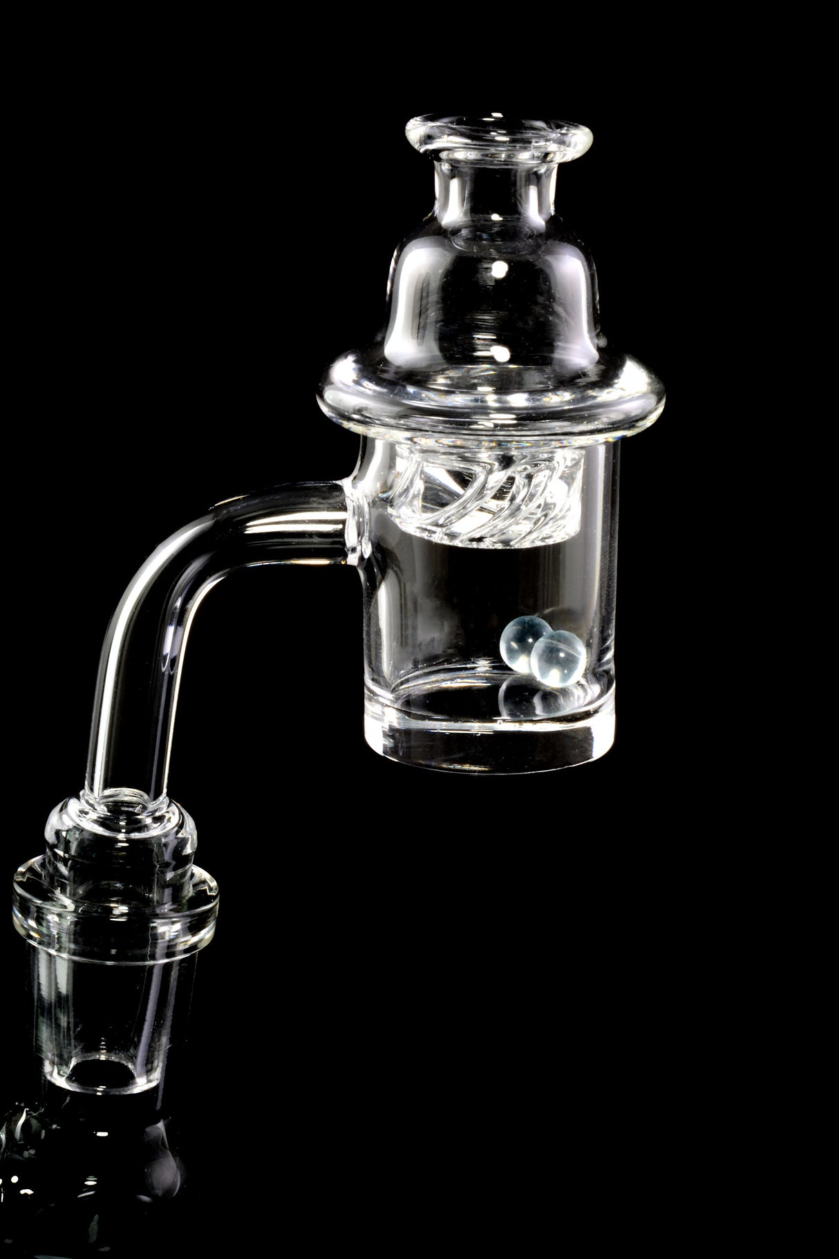 Spinner banger mounted on a rig with turbine cap; two 6 mm beads inside bucket ready for flavorful concentrate dabs.