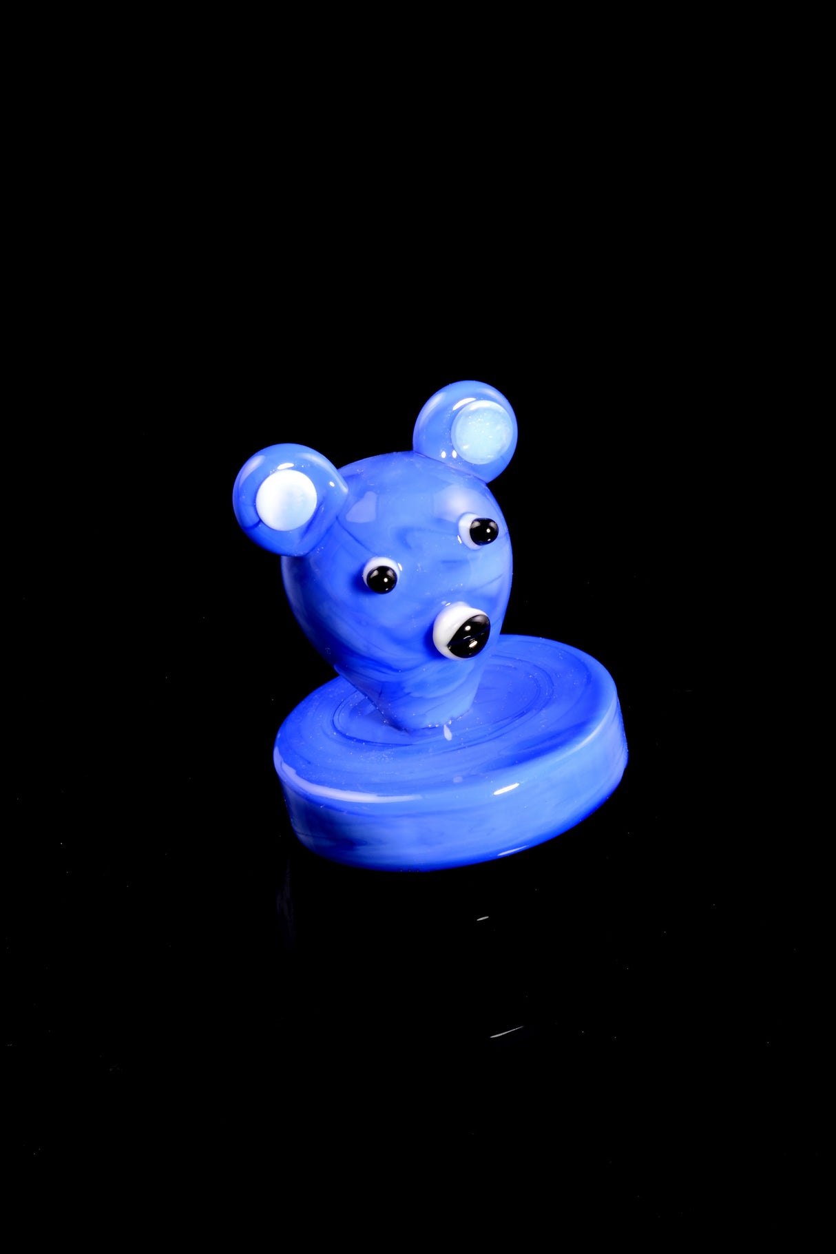 Single blue koala bear glass carb cap with flared base on black backdrop; playful accessory that helps control bucket airflow.