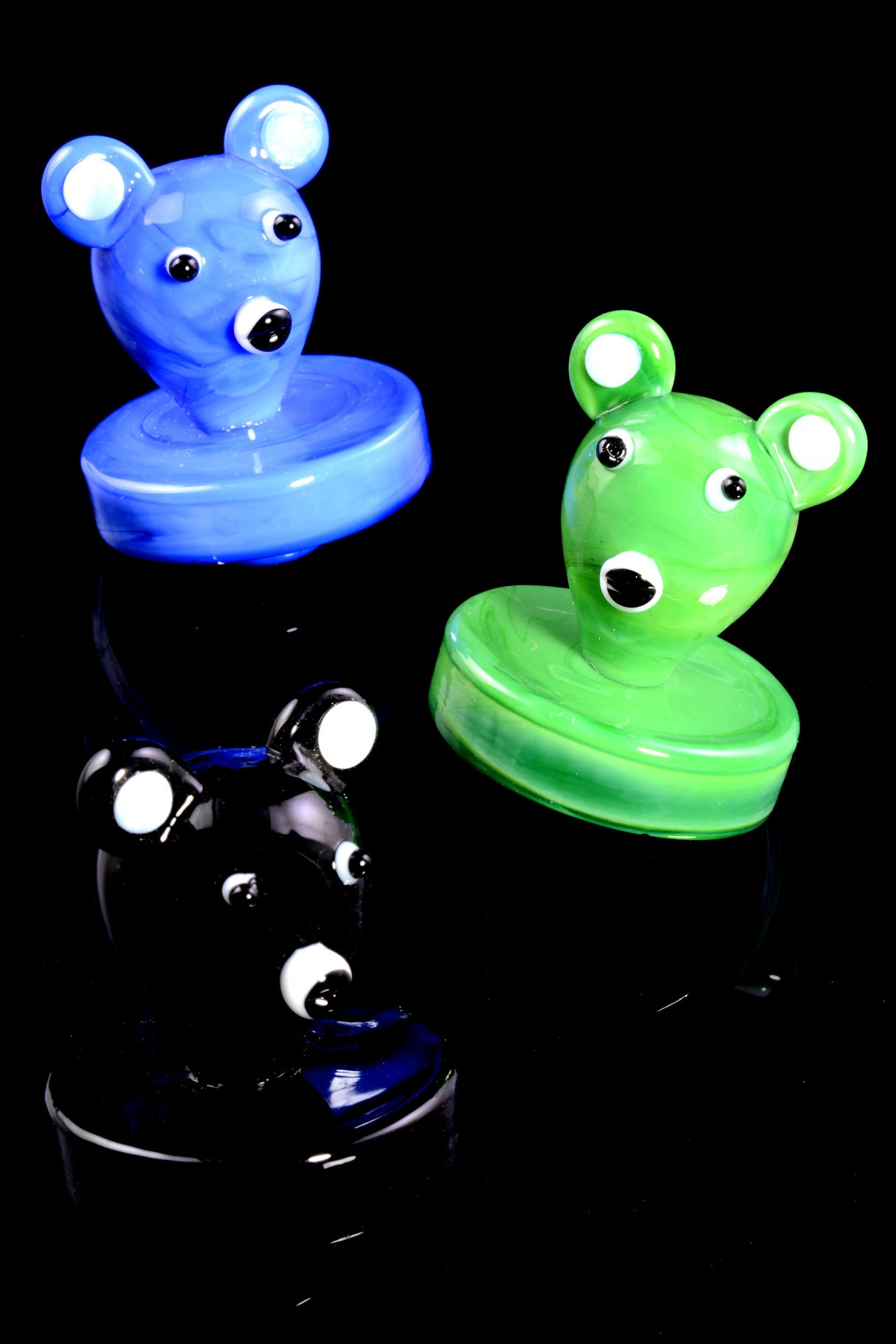 Blue, green, and black koala-themed glass carb caps shown together on black; rounded bases designed to seal flat-top buckets.