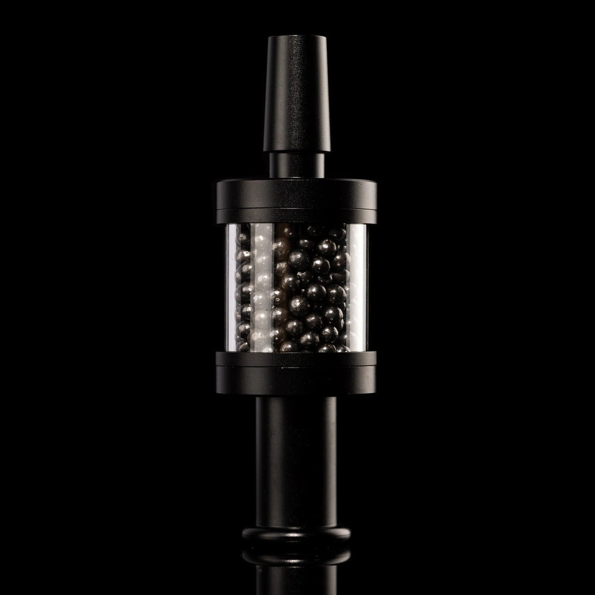 Black Flux Pike tar filter installed on matching stem, carbon bead chamber centered, 14 mm bong accessory on black backdrop.
