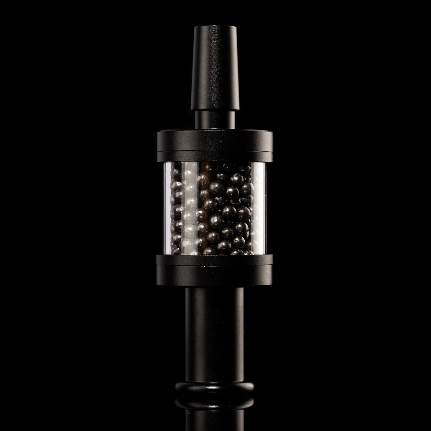 Black Flux Pike tar filter installed on matching stem, carbon bead chamber centered, 14 mm bong accessory on black backdrop.