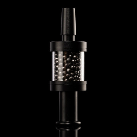 Black Flux Pike tar filter installed on matching stem, carbon bead chamber centered, 14 mm bong accessory on black backdrop.